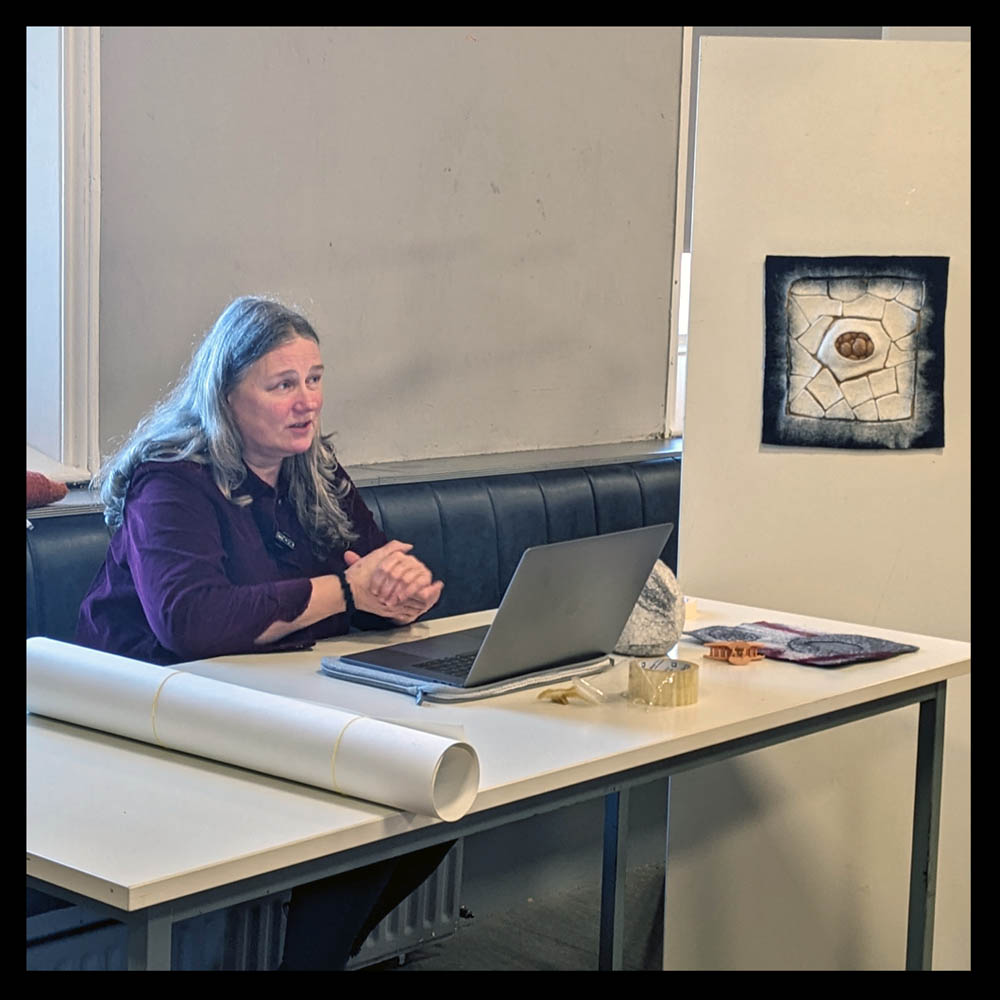 Ramona Farrelley with one her felted wall art pieces, as she talks about using an iPhone to photograph textile art for exhibitions.